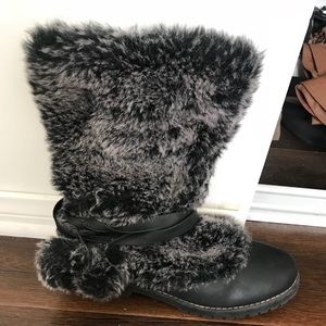 Black furry boots with pom poms